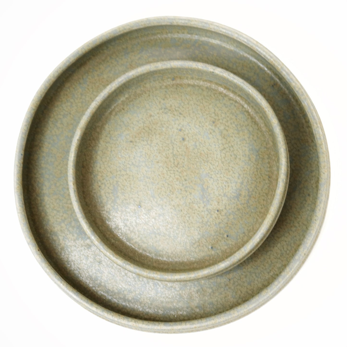 Set of two ceramic plates with a textured finish on a white background