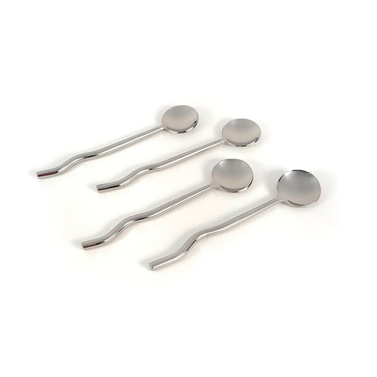 Set of four silver spoons on a white background