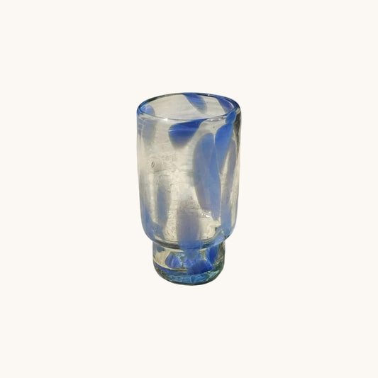 Clear glass with blue accent on a white surface