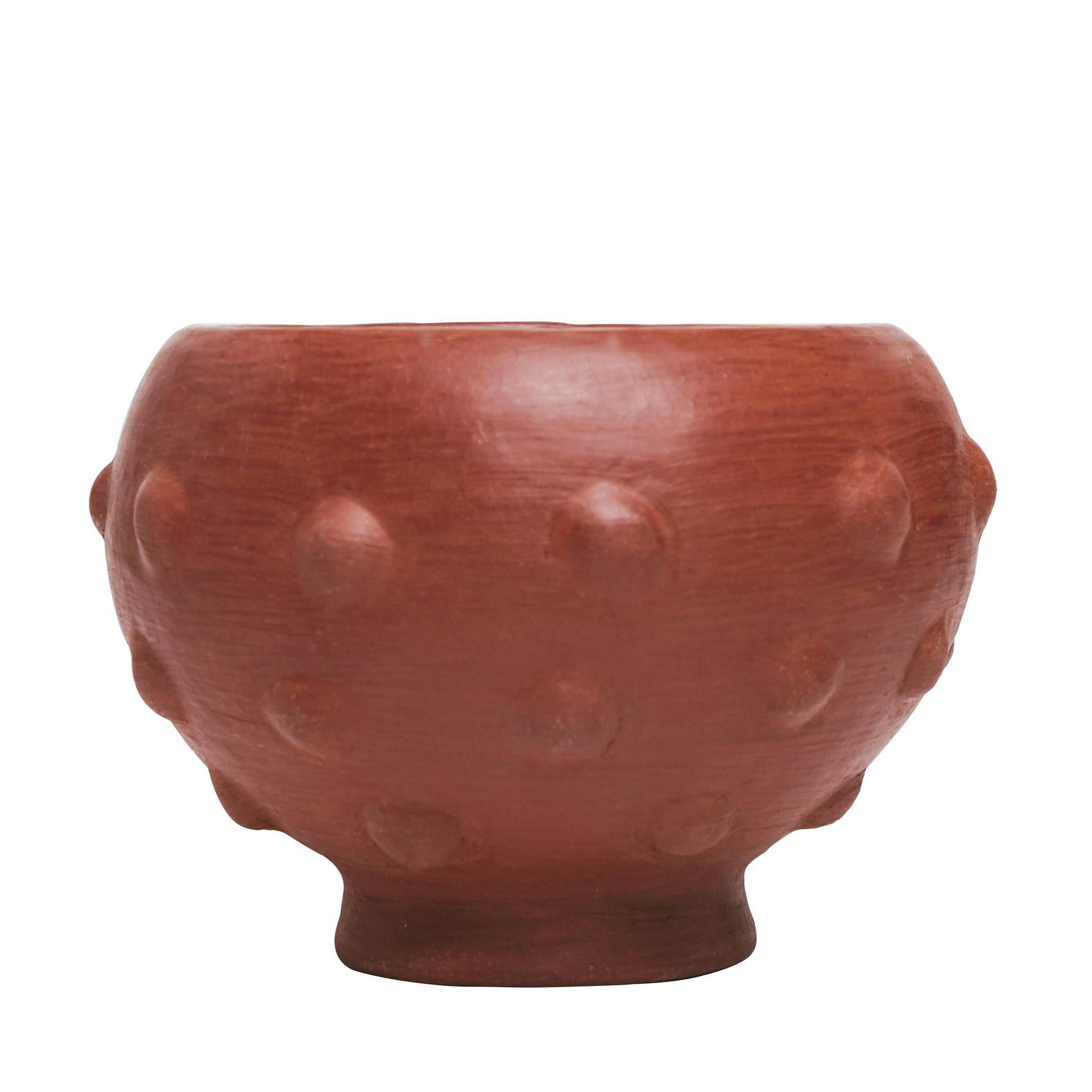 Red ceramic bowl with textured surface on a white background