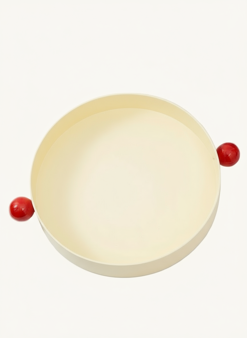 Round beige object with red accents on a white background