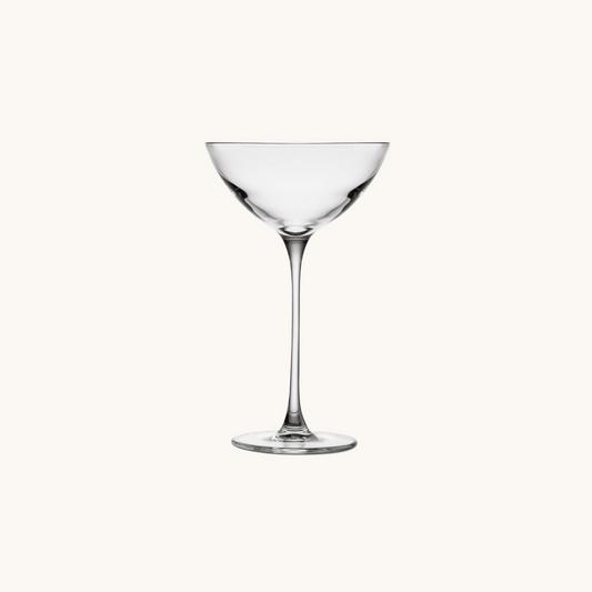 Clear glass cocktail glass on a white background