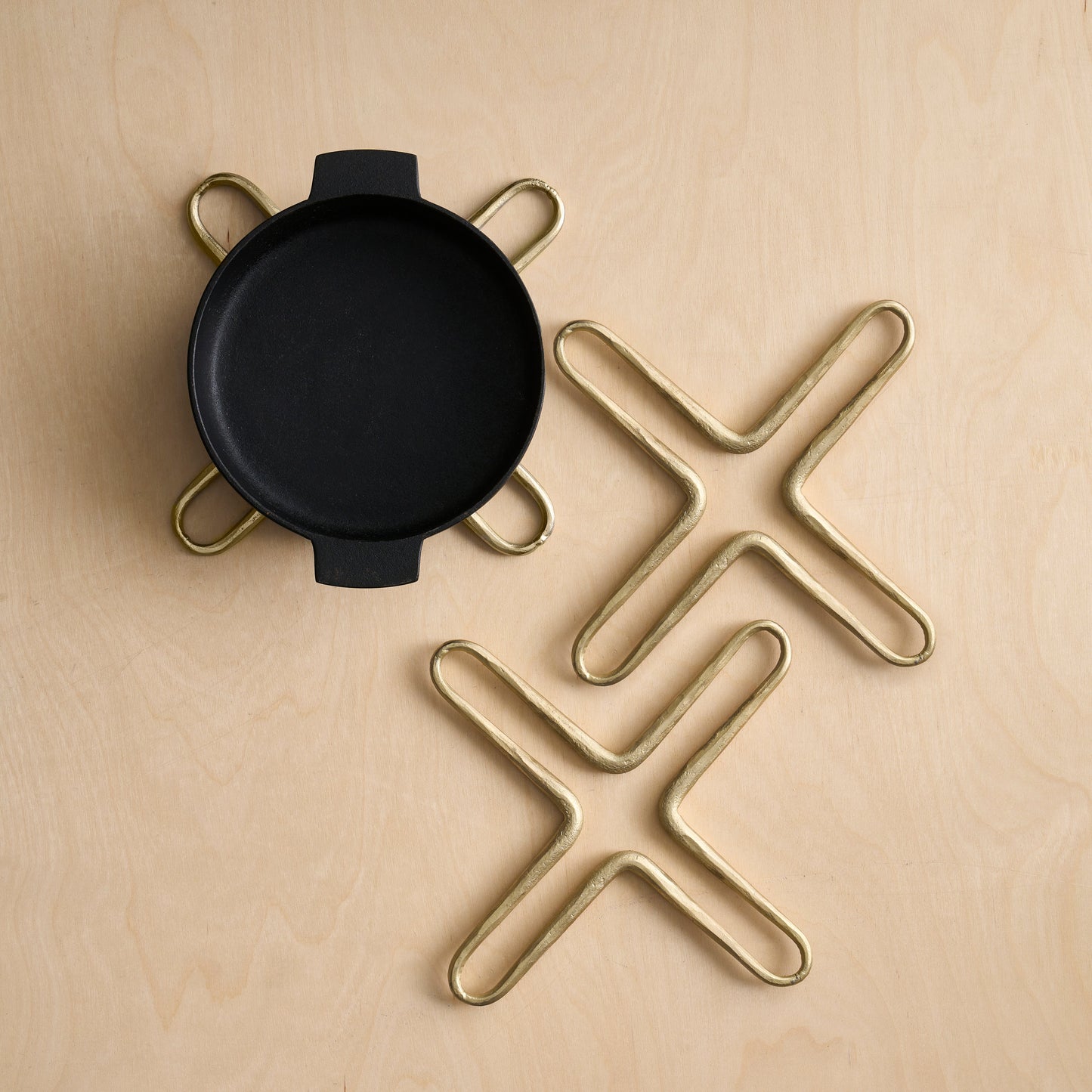 Black round object with gold star-shaped stands on a beige background