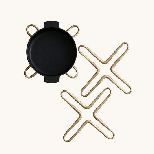 Black round object with gold geometric patterns on a white background