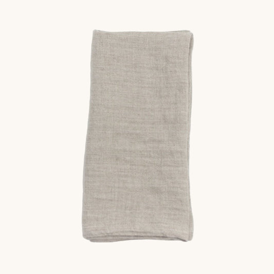 Folded beige fabric on a white background