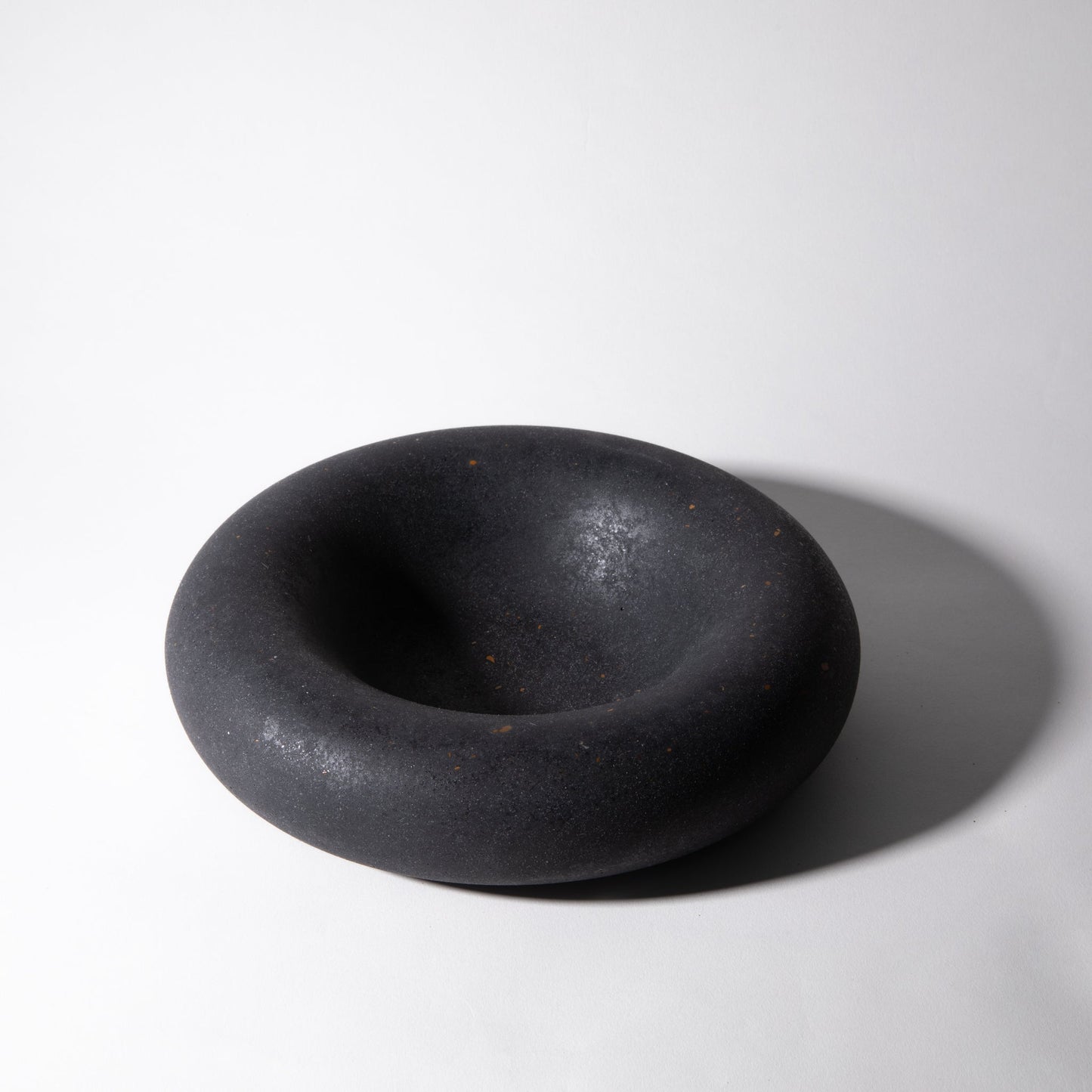 Black ceramic bowl on a white background