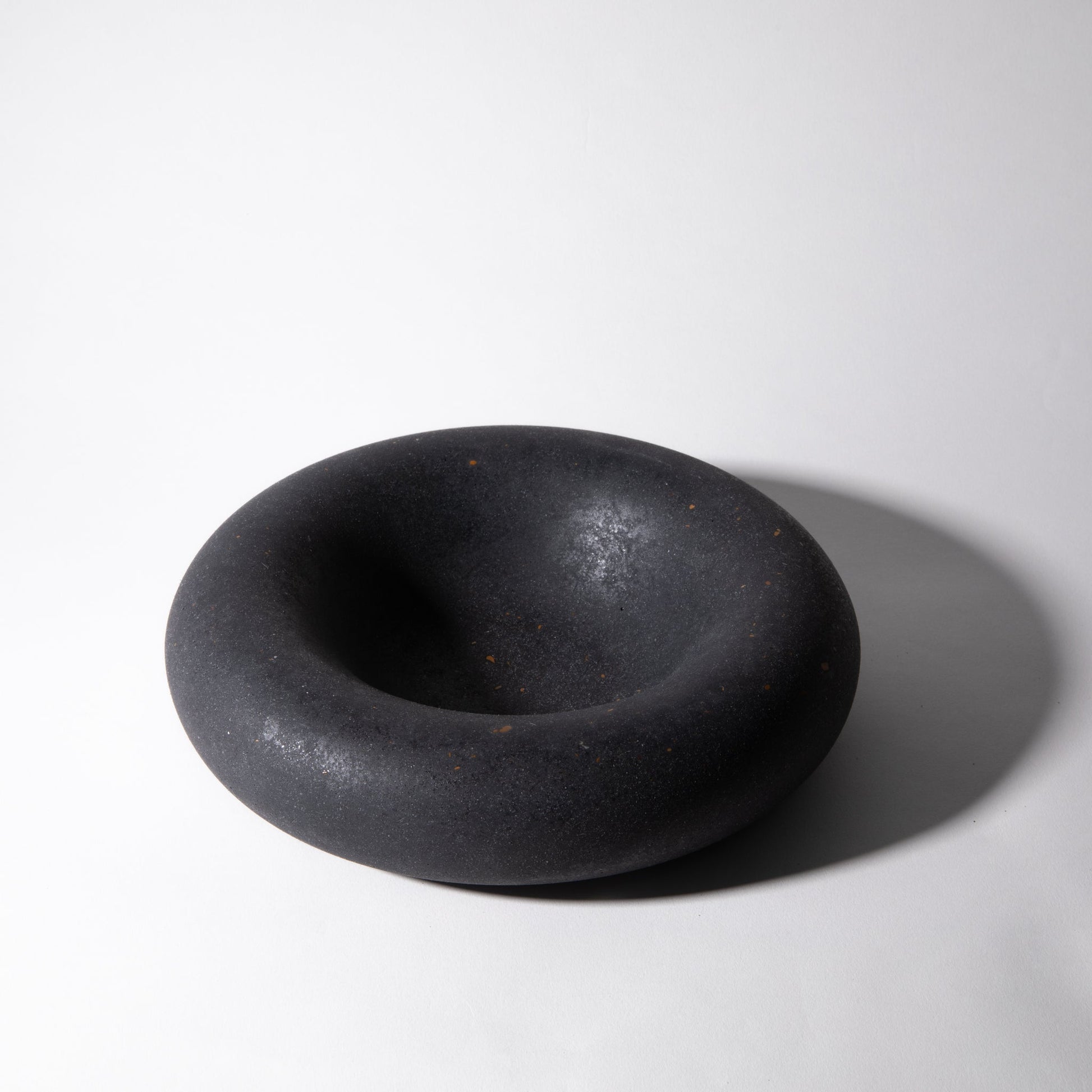 Black ceramic bowl on a white background