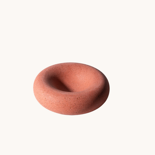 Terracotta-colored ceramic bowl on a white background