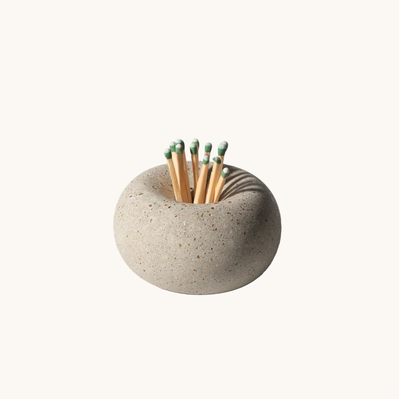 Matches in a stone-like matchbox on a white background