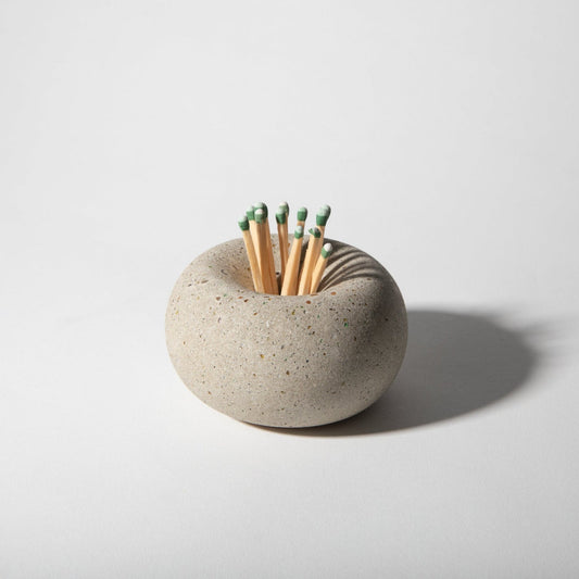 Ceramic match striker with matches on a light gray background