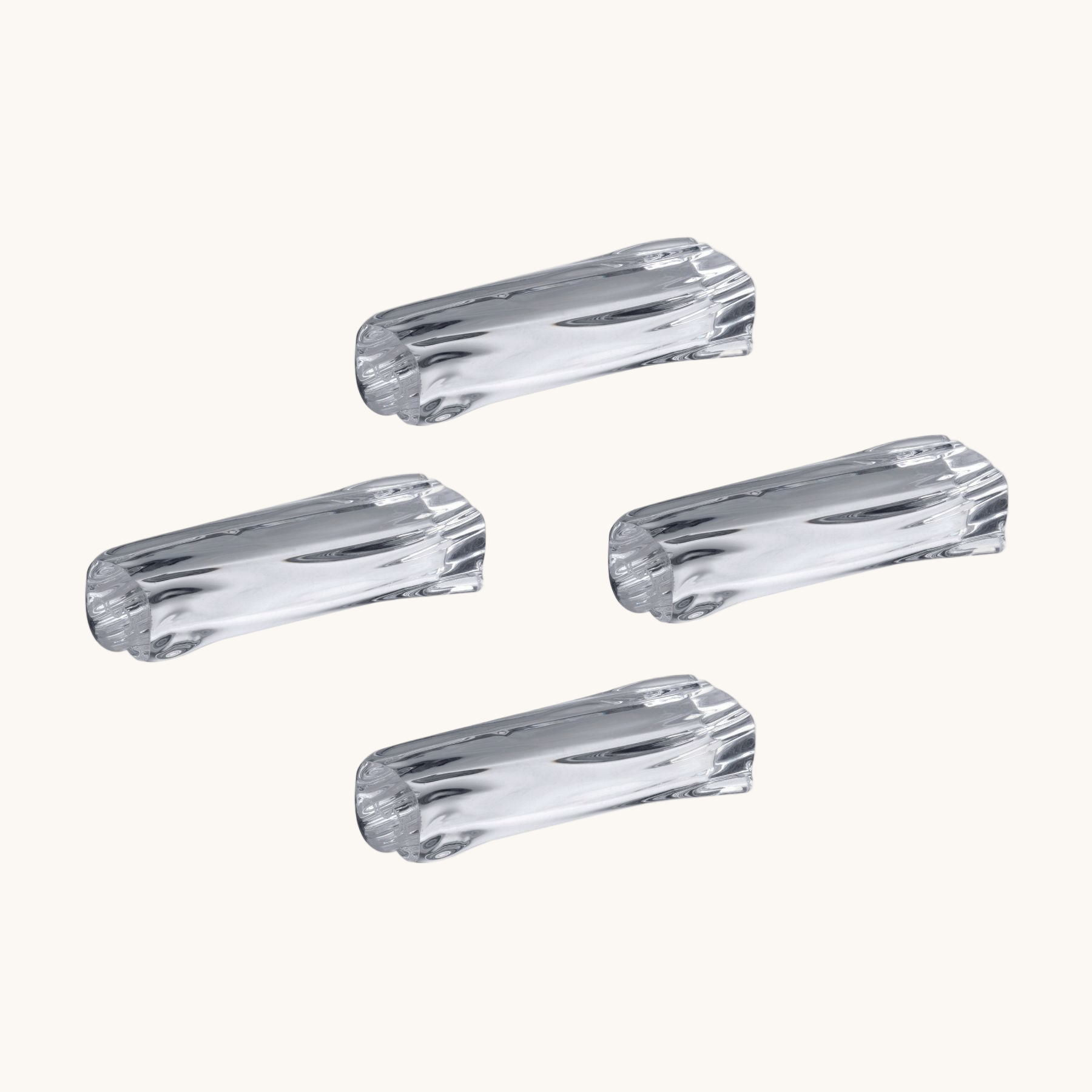 Four clear plastic knobs on a white background