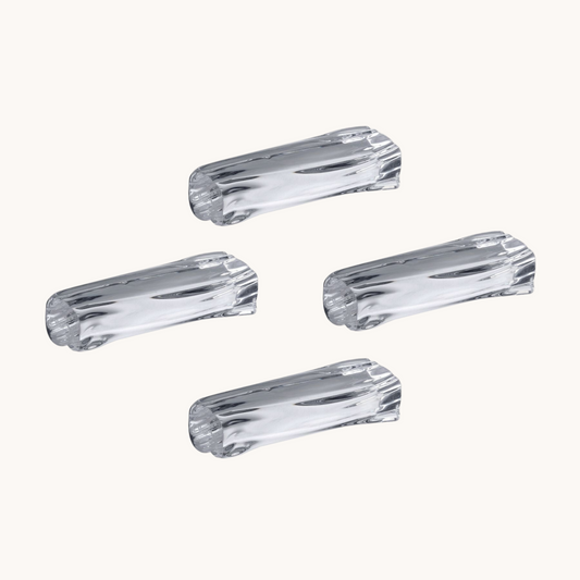 Four clear plastic knobs on a white background