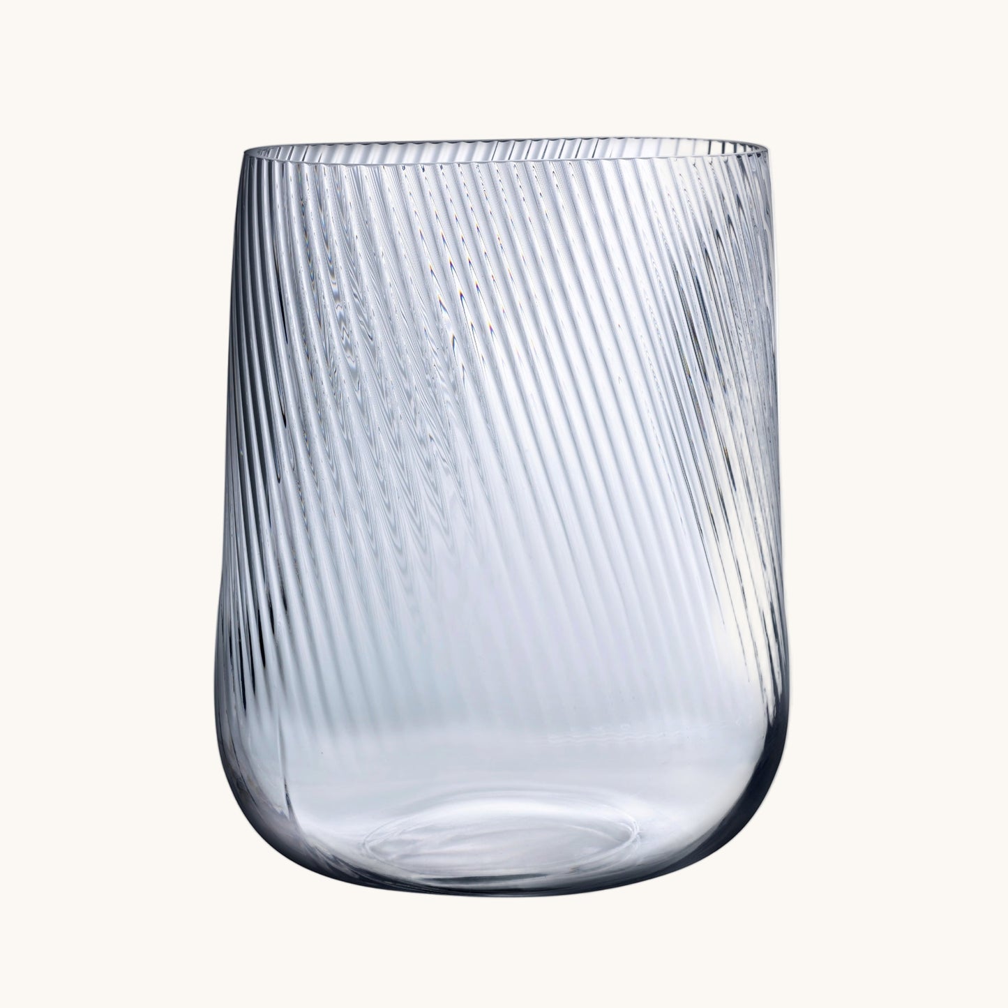 Clear glass tumbler with ribbed texture on a white background