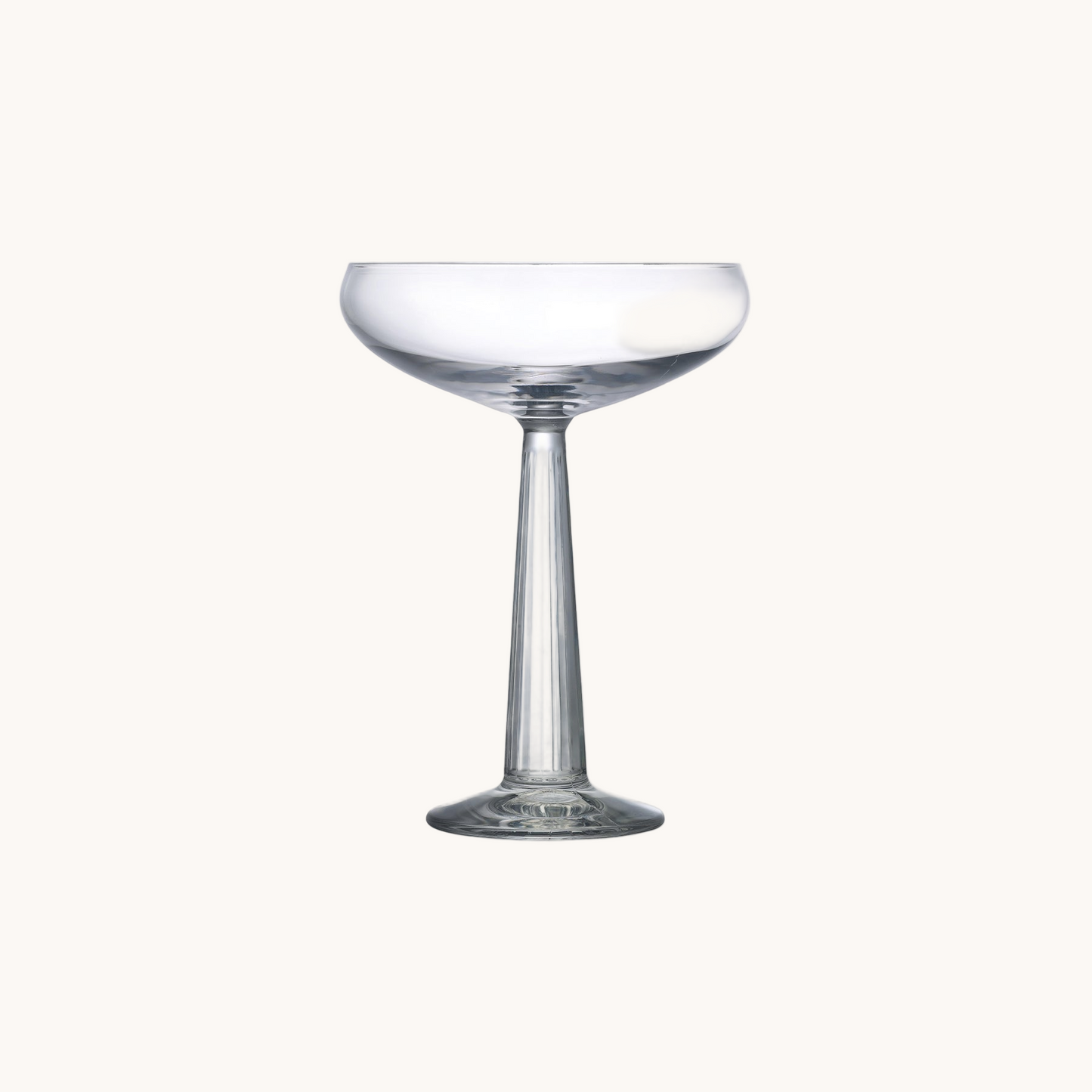Clear glass cocktail coupe on a white background