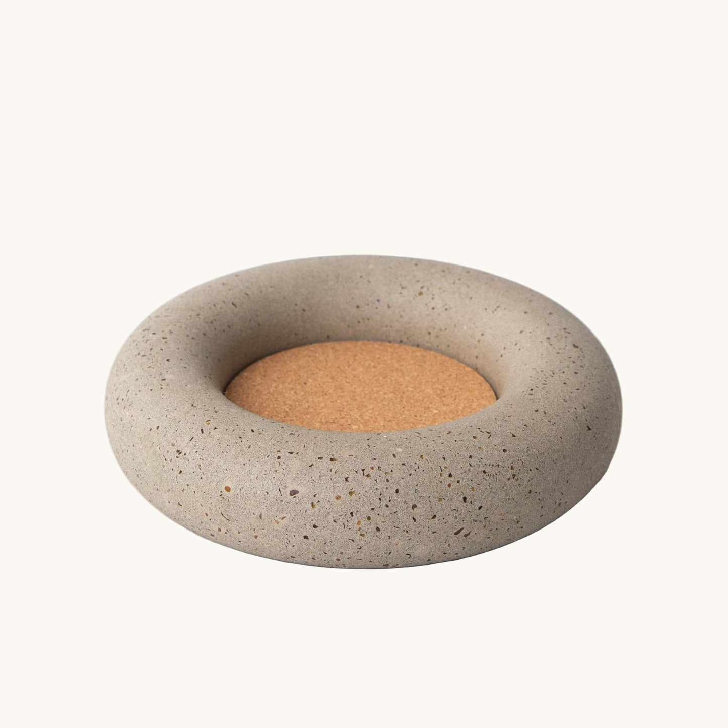 Concrete coaster with cork base on a white background