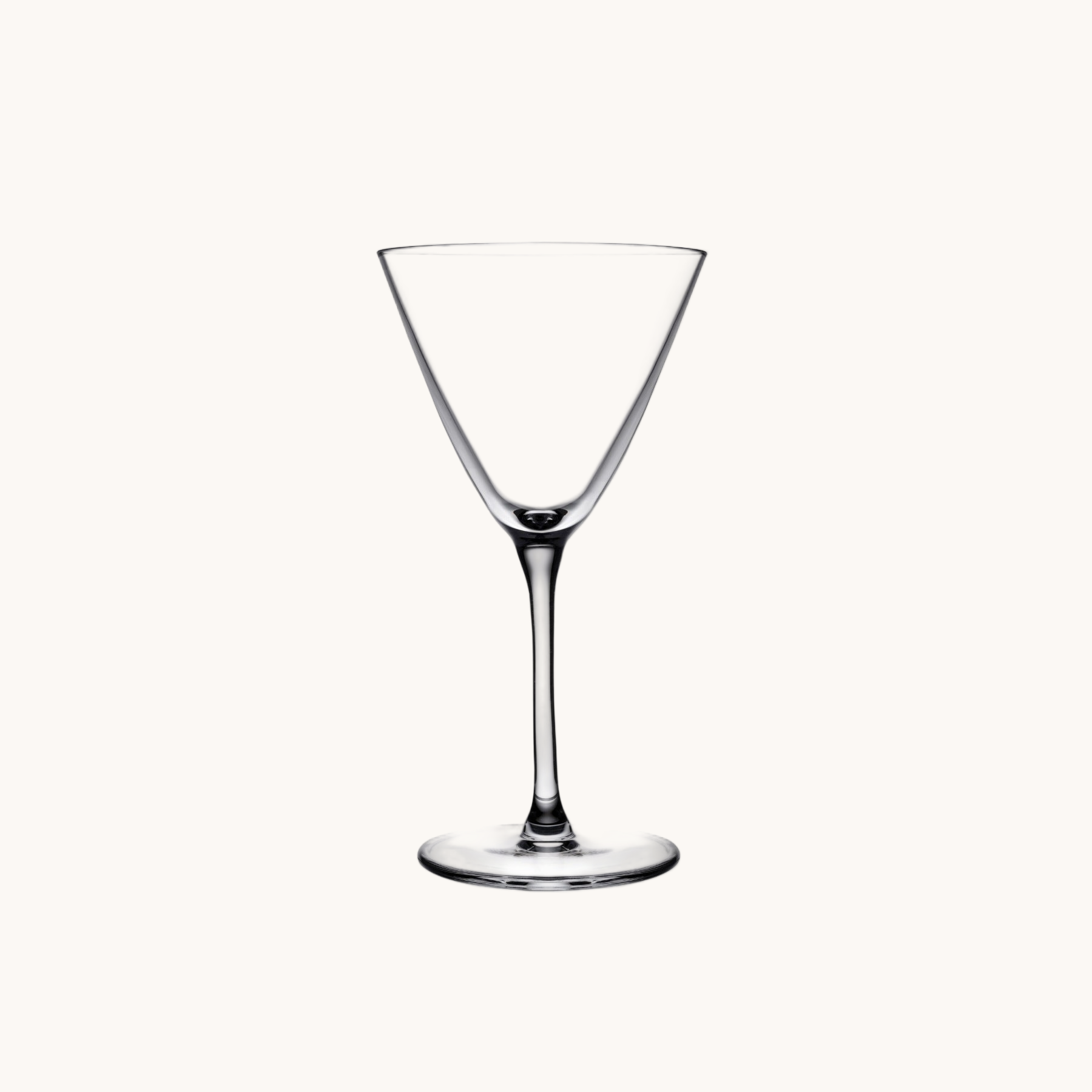 Clear glass cocktail glass on a white background