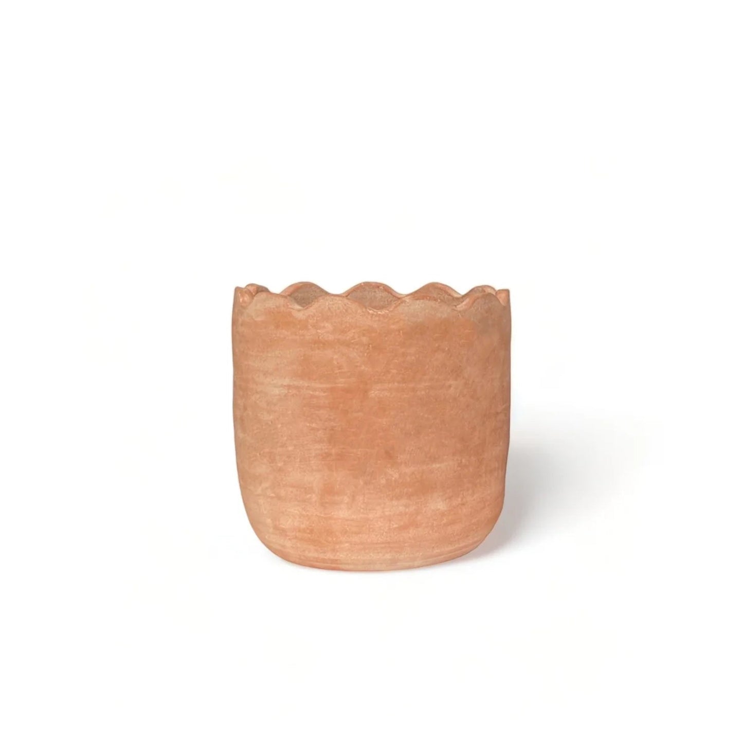 Terracotta pot with scalloped edge on a white background