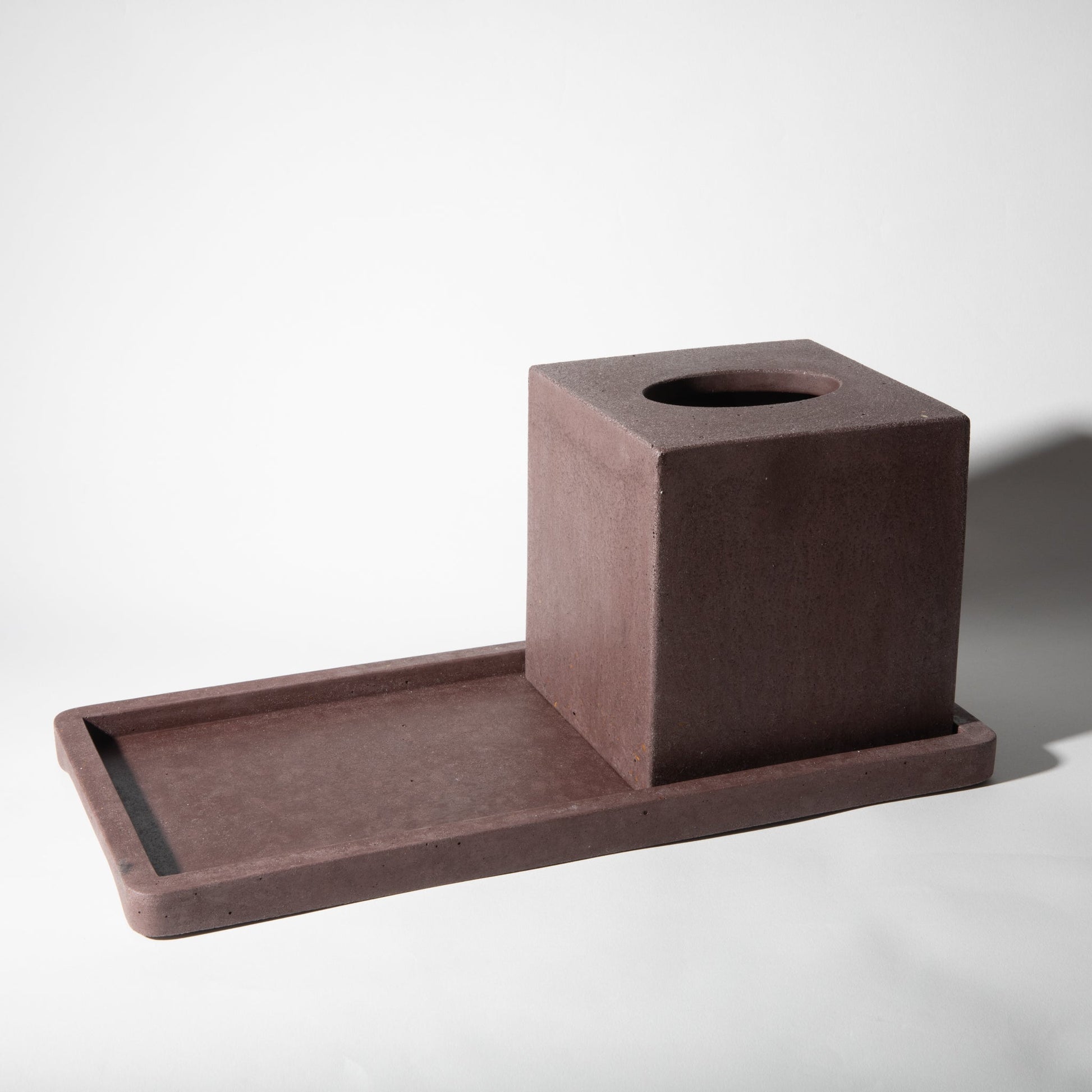 Brown concrete tray with square holder on a white background