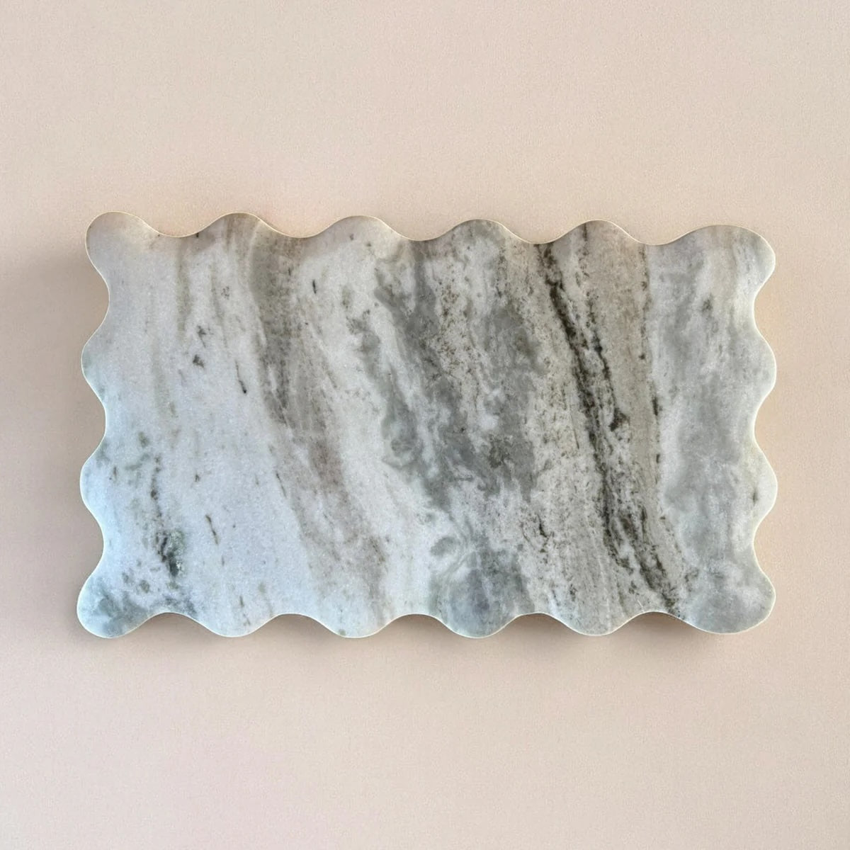 Marble-patterned stone with wavy edge on a beige background