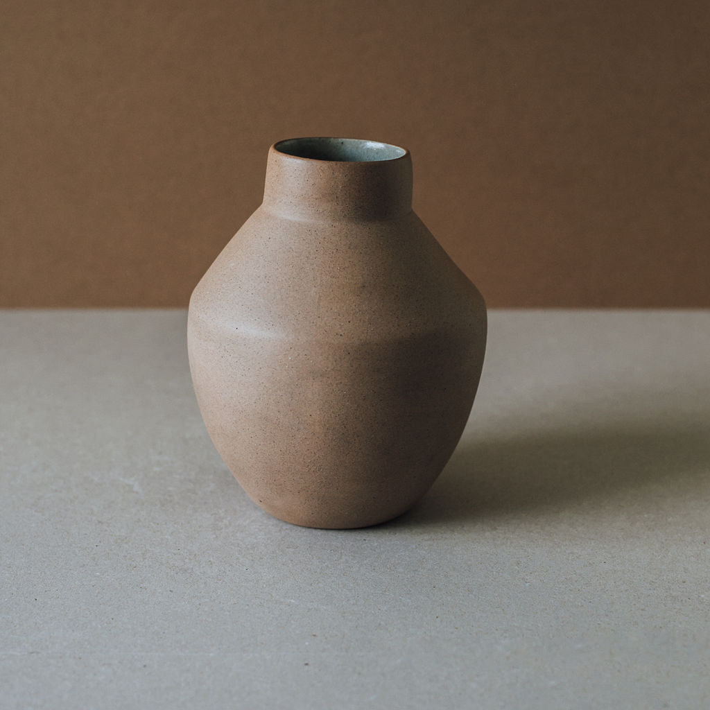 Brown ceramic vase on a neutral background