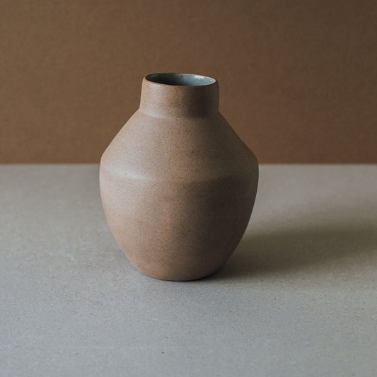Brown ceramic vase on a neutral background