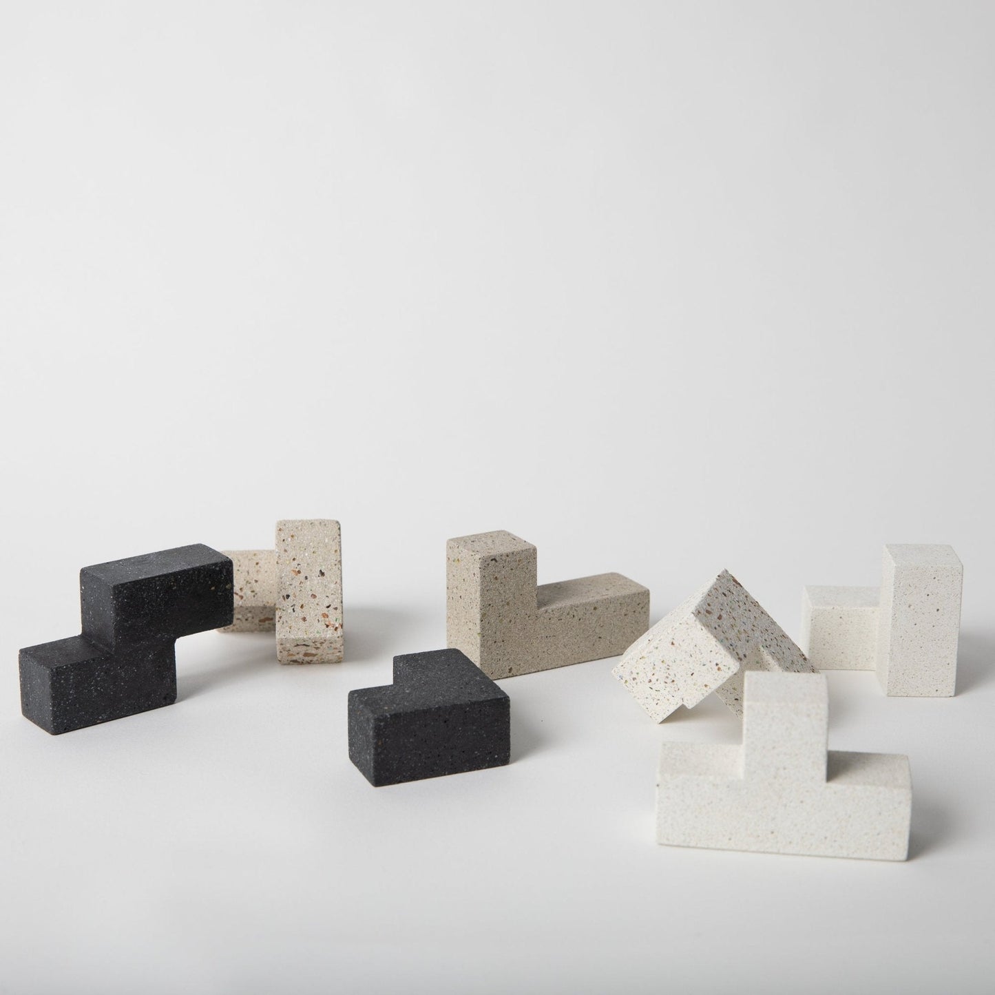 Concrete and stone block sculptures on a white background