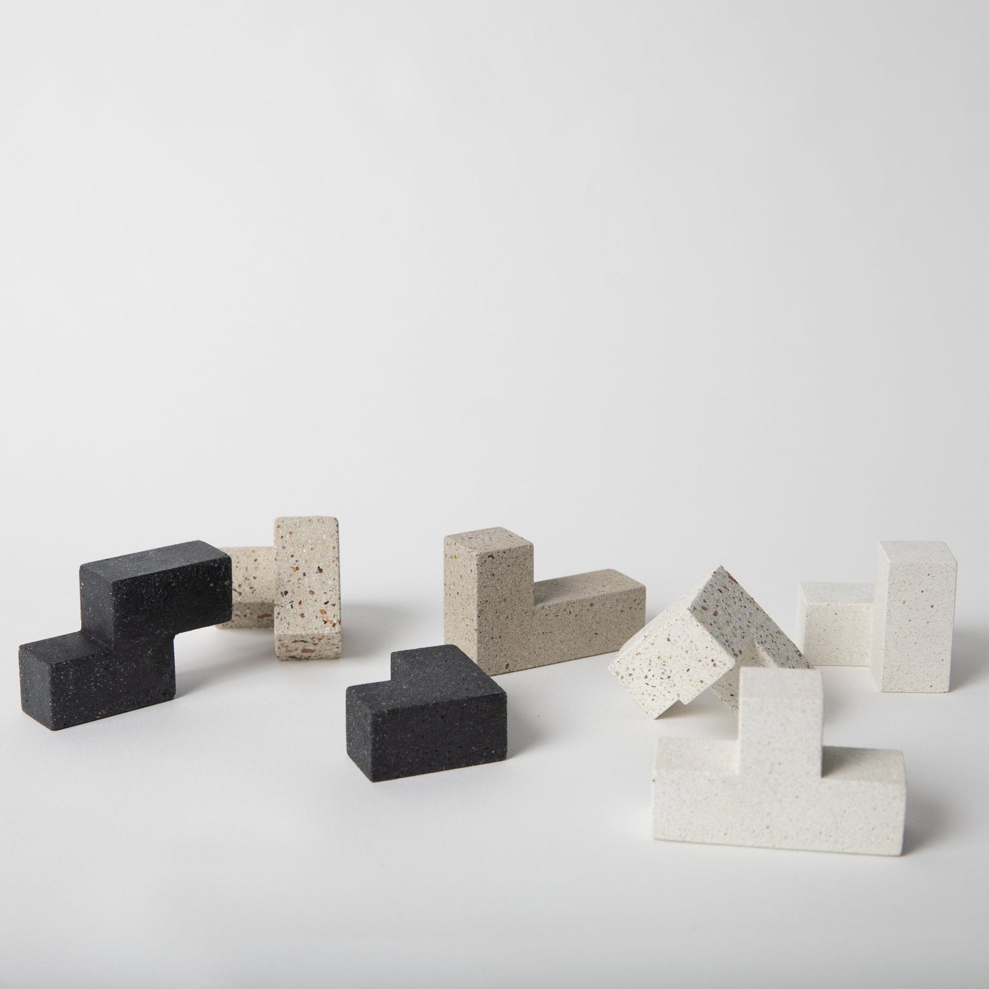 Concrete and stone block sculptures on a white background