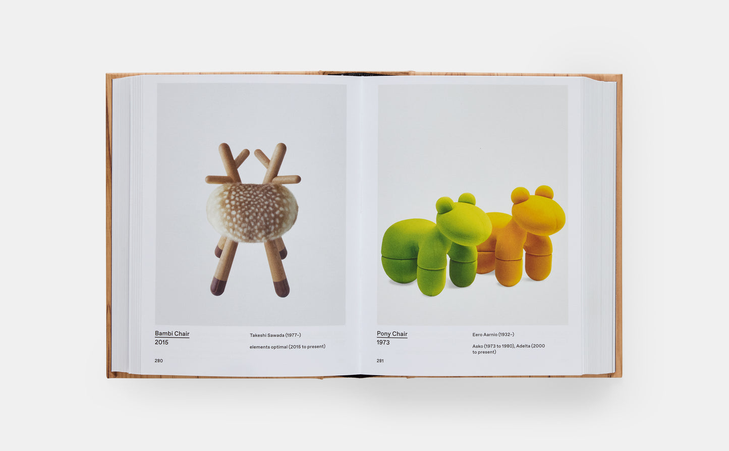 Open book displaying two plush toys on a white background