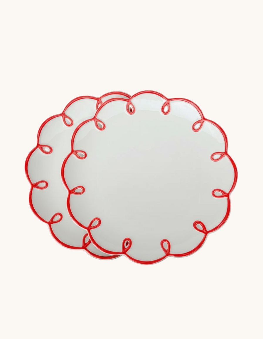 Decorative red lace pattern on a beige background